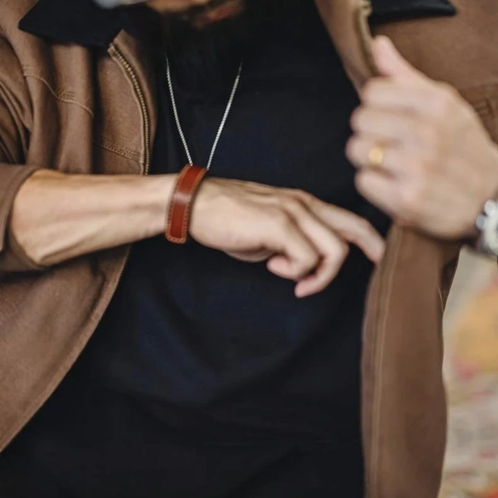 Brown Detroit jacket worn open over a black tee